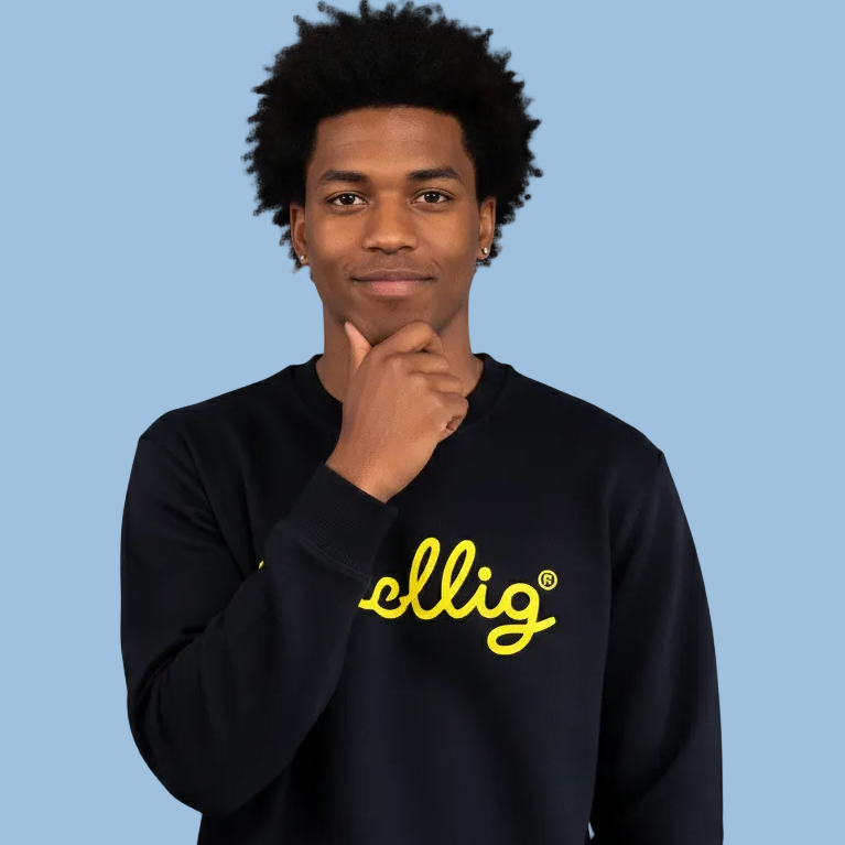 Guy wearing a black Gezellig sweatshirt with yellow logo on a blue background