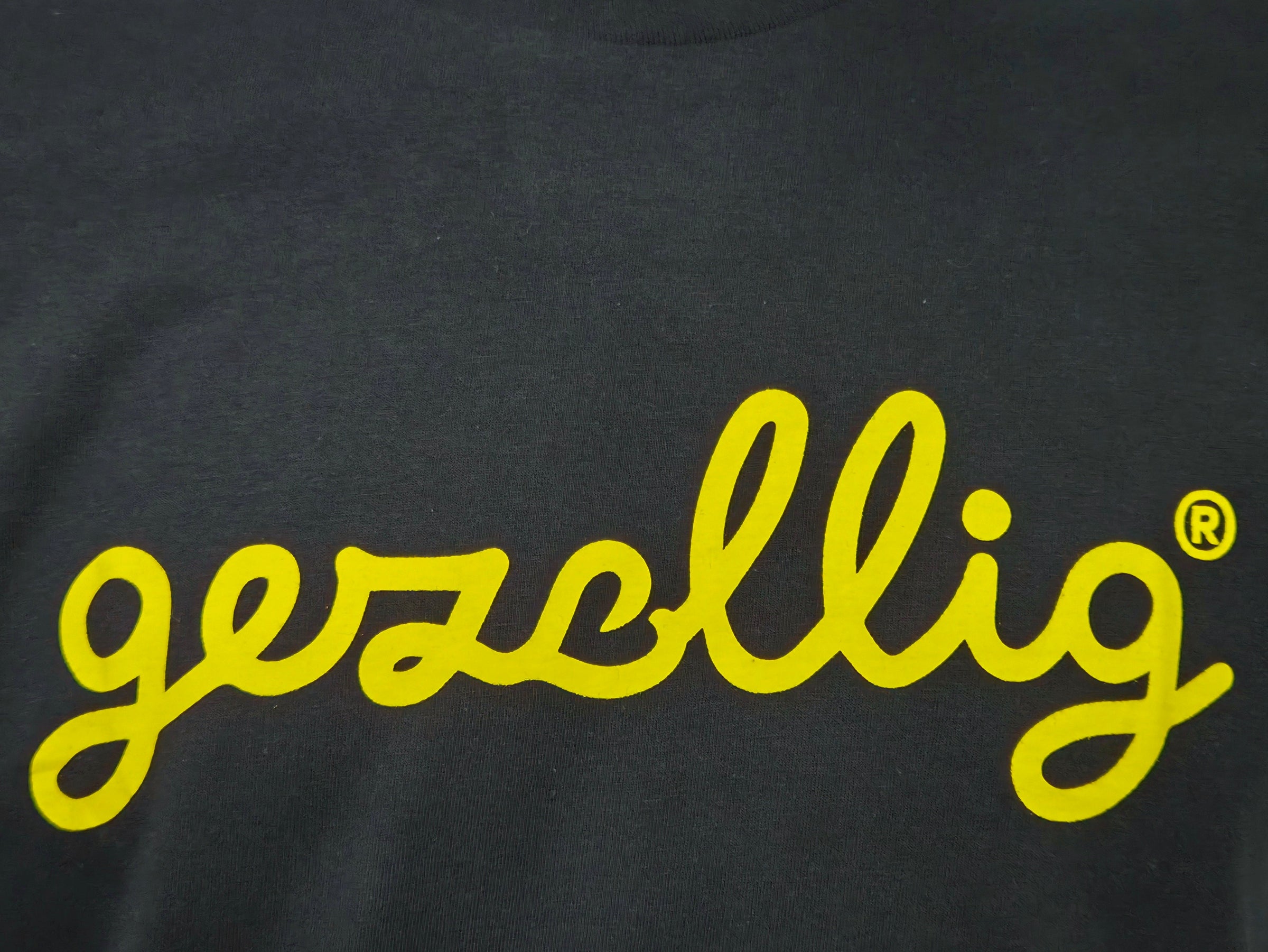 Black t-shirt with yellow 'gezellig' logo
