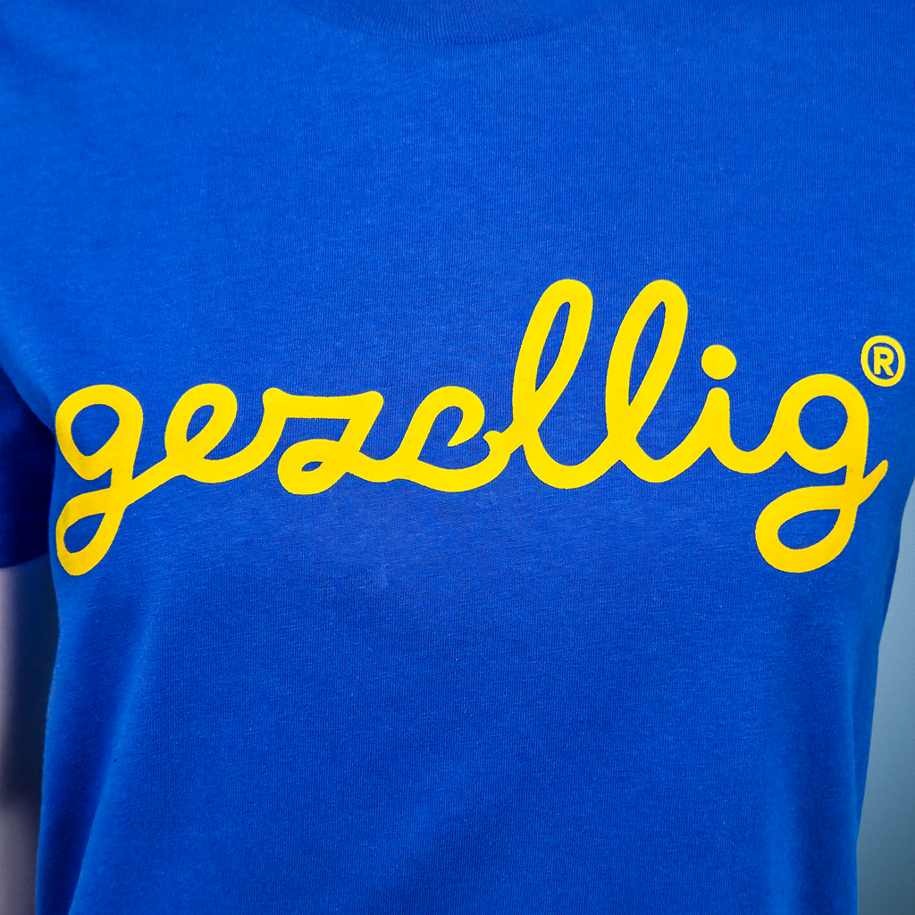 Royal blue t-shirt with yellow 'gezellig' logo

