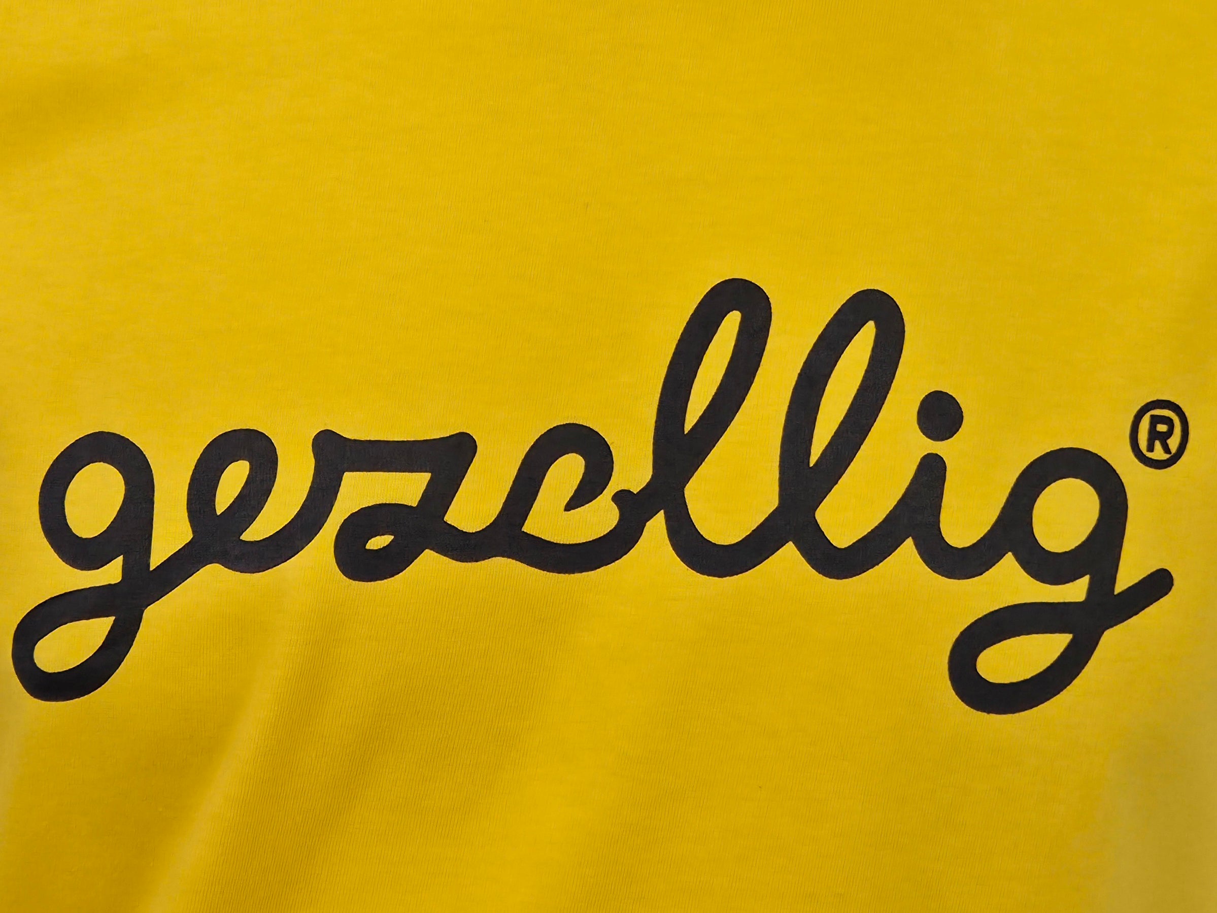 Yellow t-shirt with black 'gezellig' logo