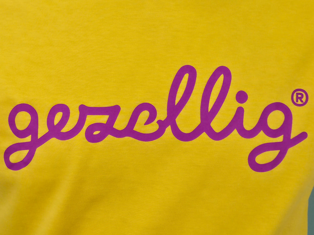 Yellow t-shirt with fuchsia  'gezellig' text

