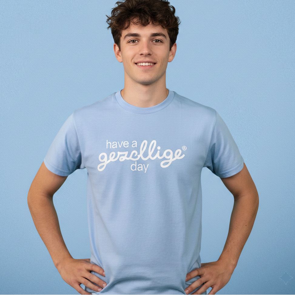 Person wearing a light blue t-shirt with text on a solid background